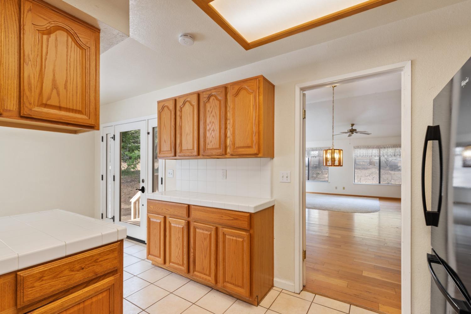 40809 Jean Road West Oakhurst, CA 93644 - Photo 16 of 39 a kitchen with stainless steel appliances granite countertop a refrigerator a stove and a sink with cabinets