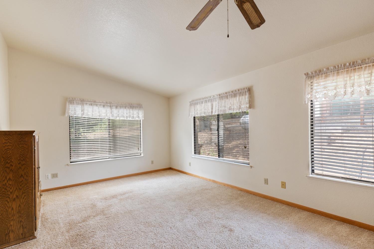 40809 Jean Road West Oakhurst, CA 93644 - Photo 21 of 39 an empty room with chandelier fan and windows
