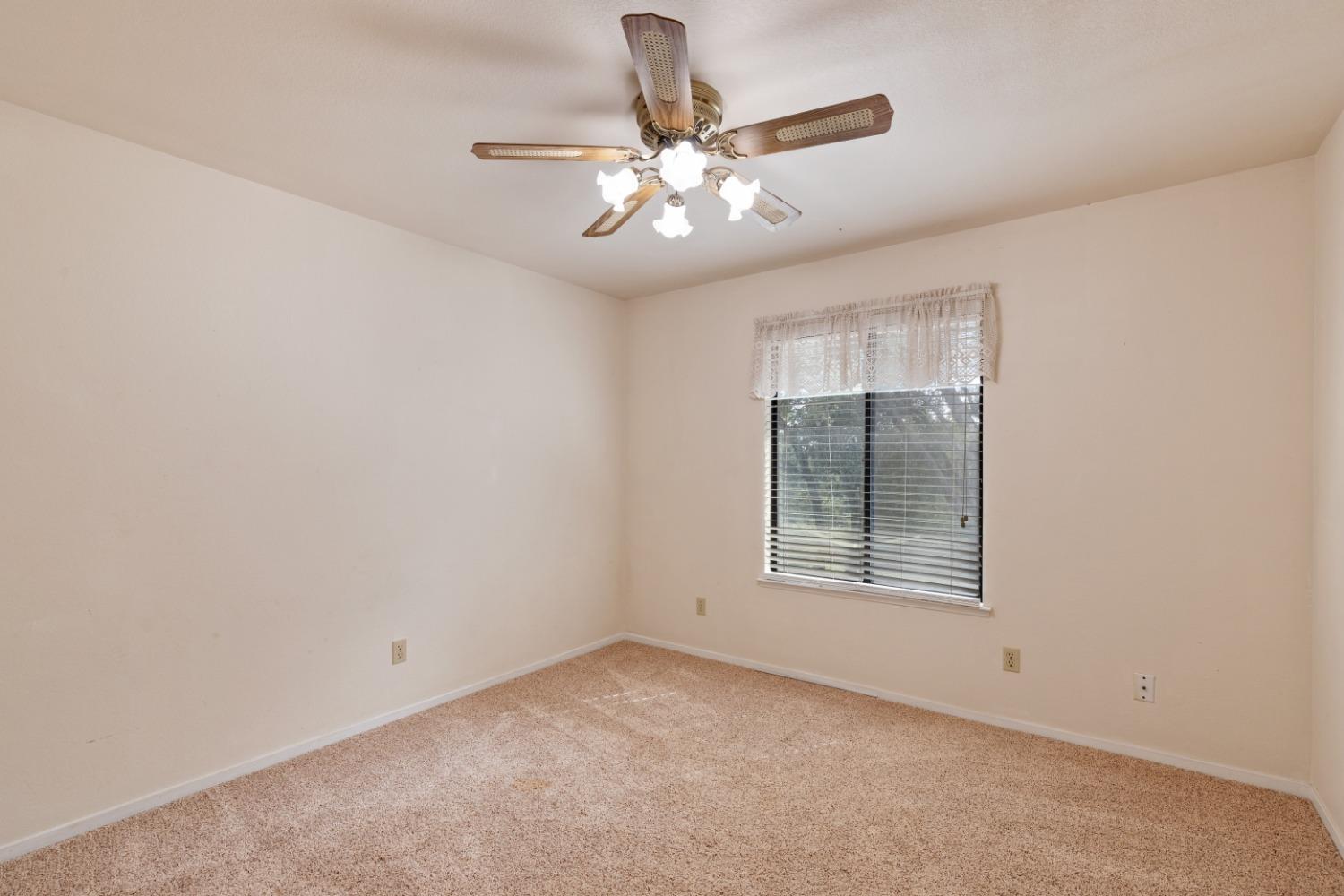 40809 Jean Road West Oakhurst, CA 93644 - Photo 24 of 39 an empty room with chandelier fan and windows