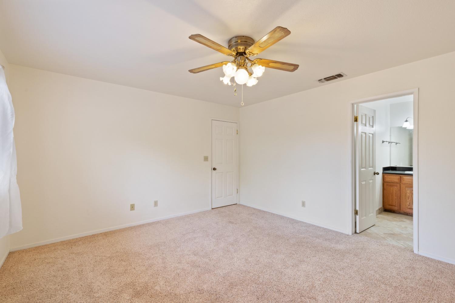 40809 Jean Road West Oakhurst, CA 93644 - Photo 28 of 39 an empty room with a chandelier fan and closet
