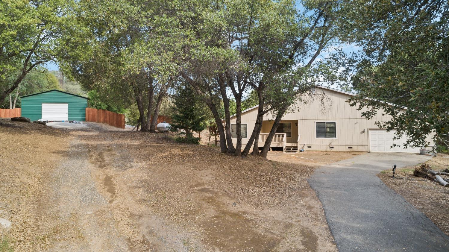 40809 Jean Road West Oakhurst, CA 93644 - Photo 6 of 39 a view of a house with a yard and garage