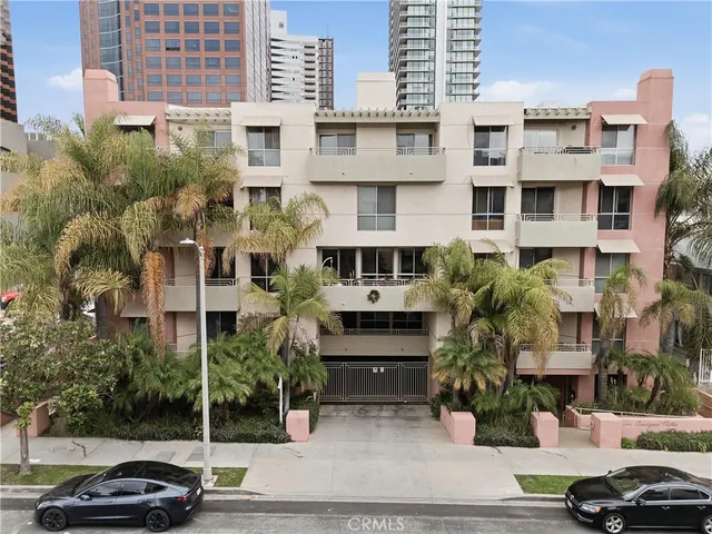 a couple of cars parked in front of a building