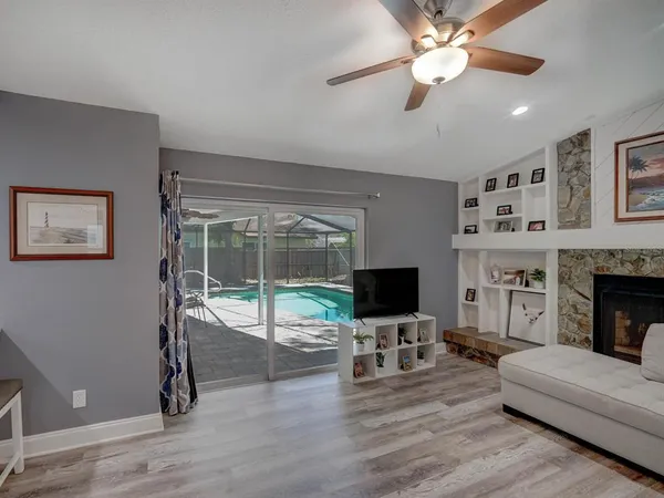 a living room with furniture a flat screen tv and a fireplace