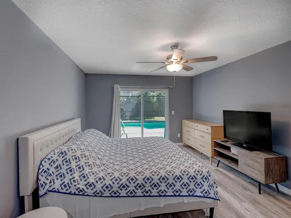 a bedroom with a bed and a flat screen tv