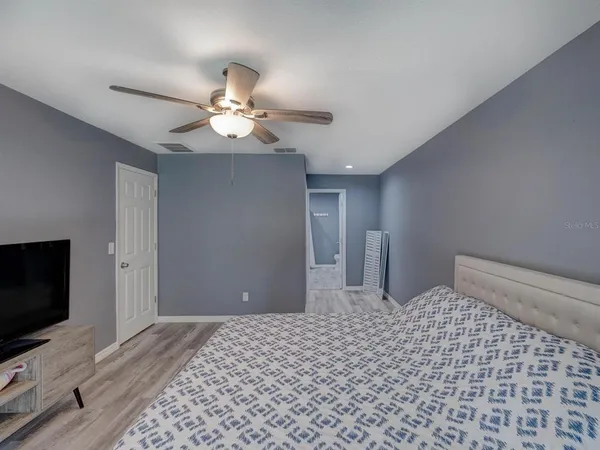 a bedroom with a bed and a flat screen tv