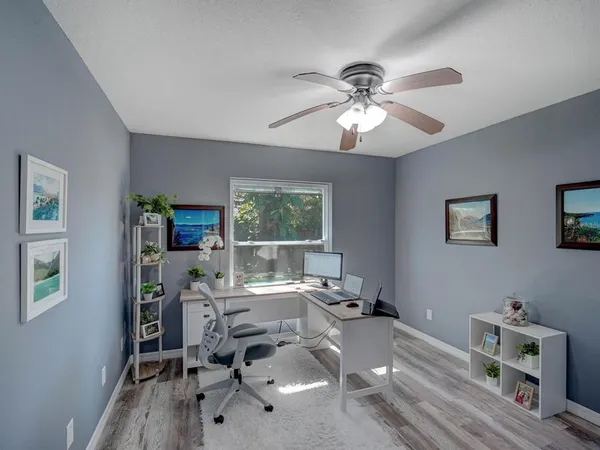a workspace with furniture hardwood and a window