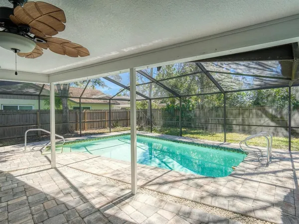 a view of a backyard with a swimming pool