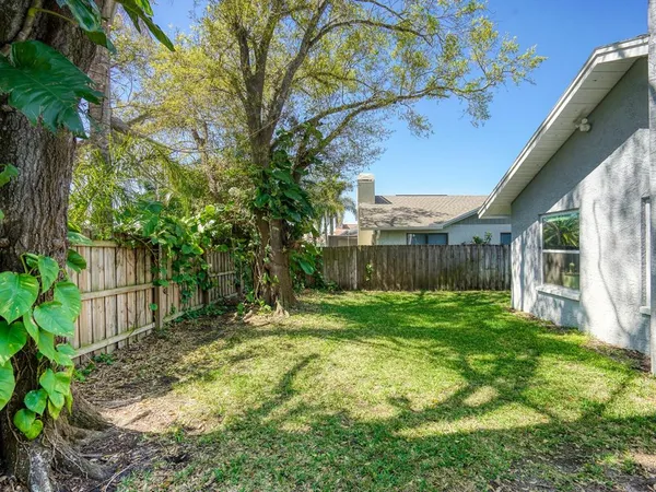 a view of house with backyard outdoor seating and hardwood