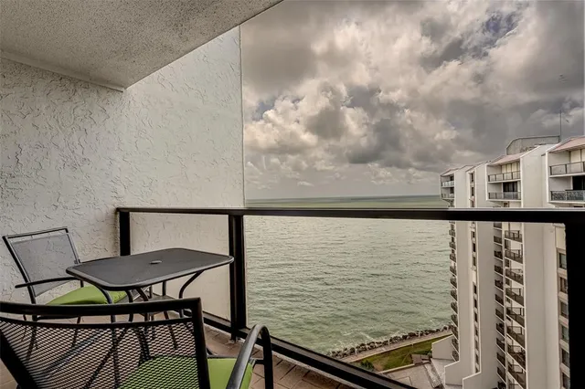 a view of a balcony with furniture and a table