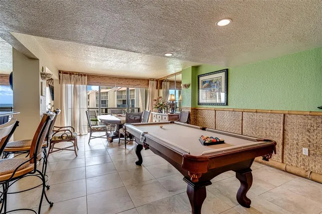 a bedroom with two beds and large window