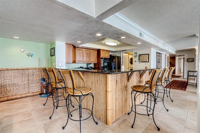 a bathroom with a granite countertop sink a toilet and a mirror