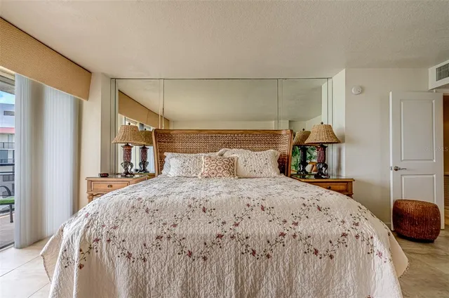 a bedroom with a bed and a painting on the wall