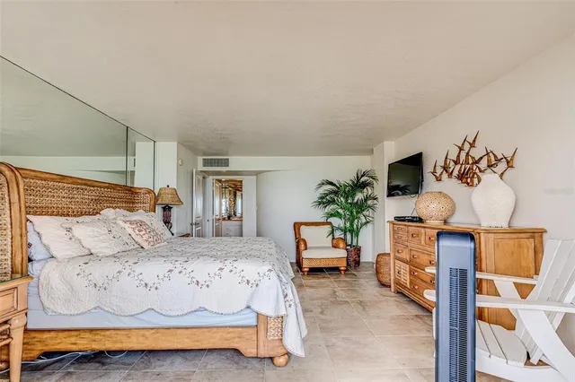 a bedroom with two beds and a lamp on dresser