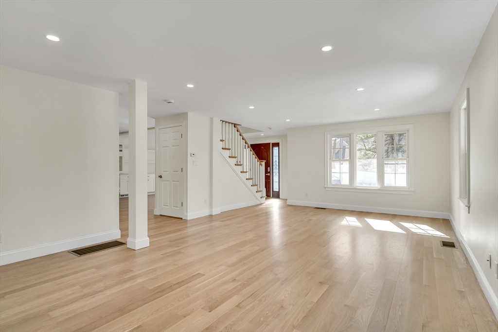 510 Common Street Walpole, MA 02081 - Photo 3 of 35 a view of an empty room with wooden floor and a window