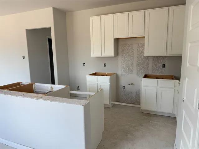 a room with a sink and cabinets