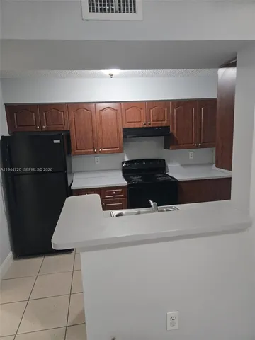 a kitchen with a stove and a refrigerator