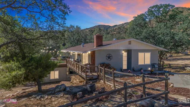 a front view of a house with yard and green space