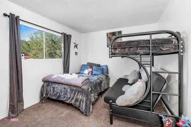 a bedroom with bed and a window