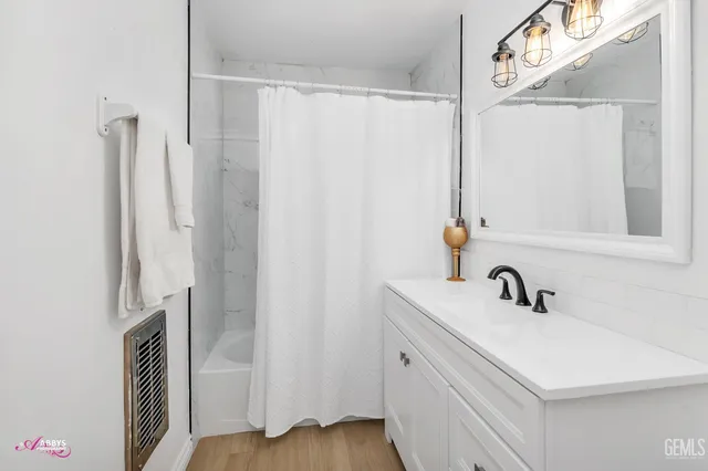 a bathroom with a sink a mirror and a shower