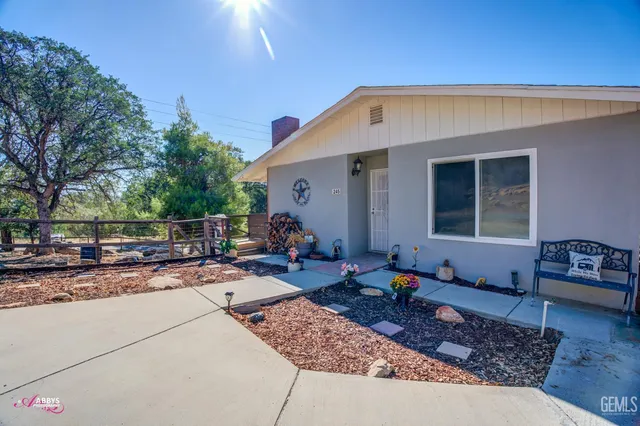 a view of a house with backyard and sitting area