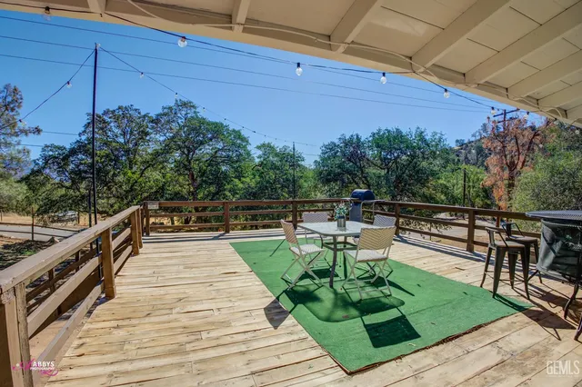 a view of a patio with table and chairs potted plants with wooden floor