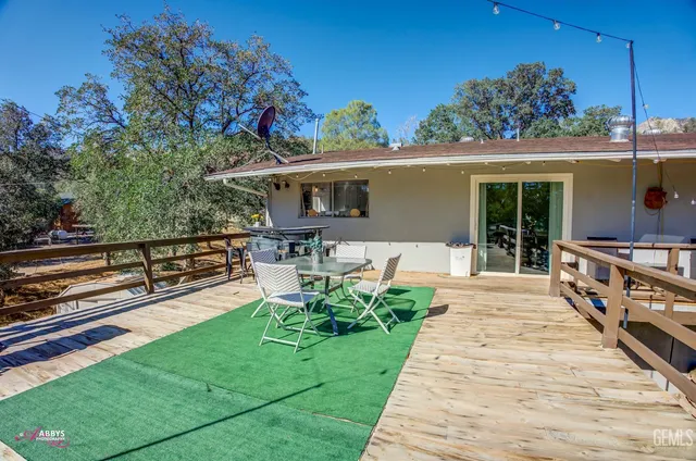 a view of a house with backyard porch and sitting area