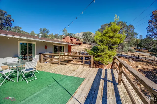 a view of a yard covered with snow in front of house