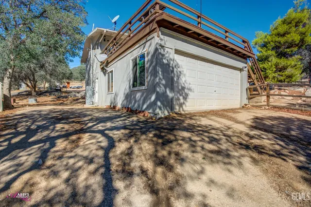a view of house with trees in front of it