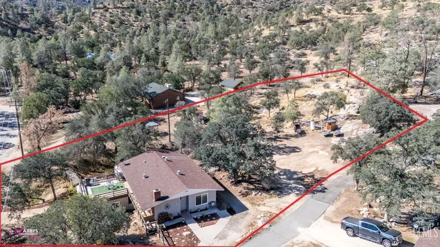 a view of a patio with table and chairs with wooden floor and fence