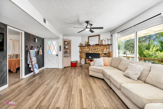 a living room with furniture fireplace and a large window