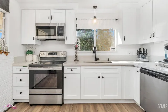 a kitchen with a sink stove and microwave