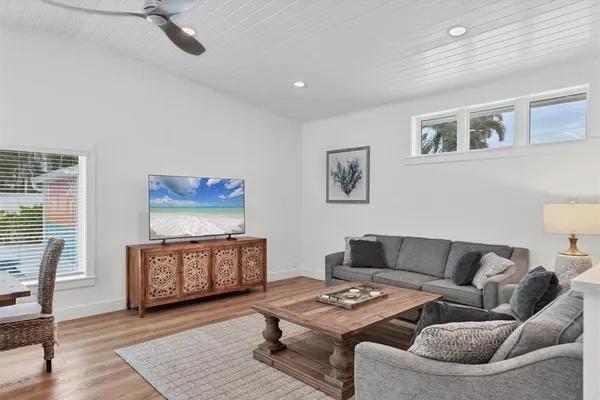 a living room with furniture and a kitchen view