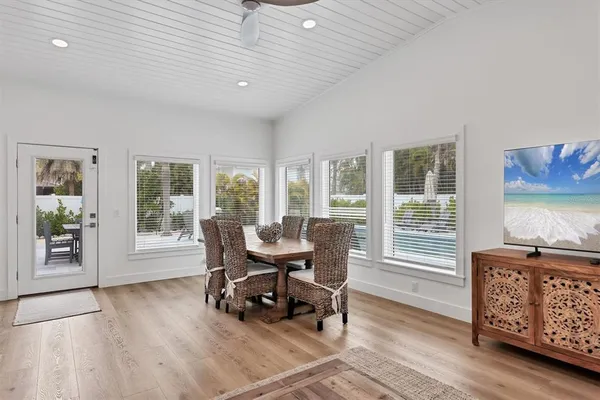 a kitchen with stainless steel appliances a sink a stove a microwave a refrigerator a sink and cabinets