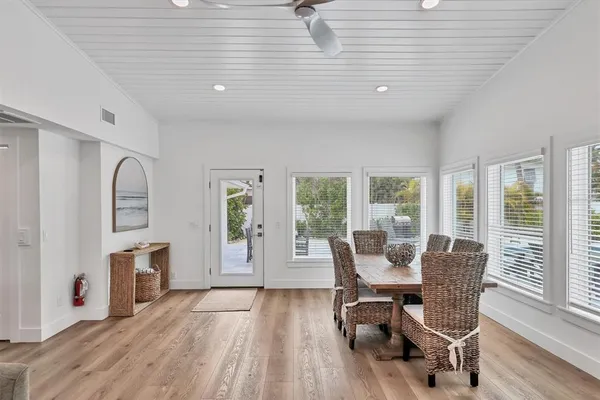 a kitchen with a table chairs sink and cabinets