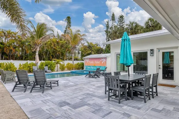 a view of a house with swimming pool and sitting area