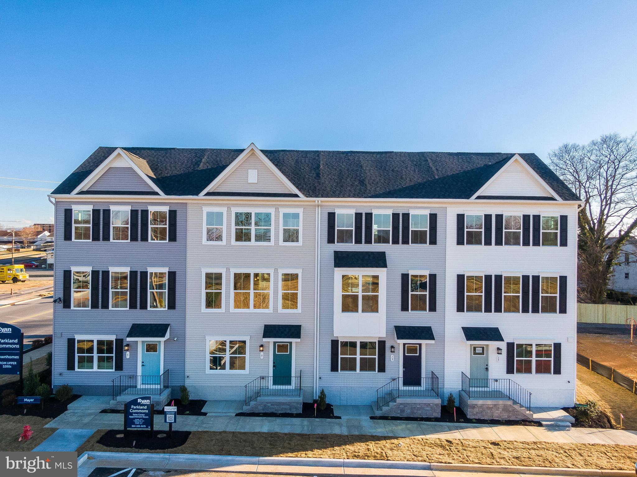 a front view of a residential apartment building with a yard
