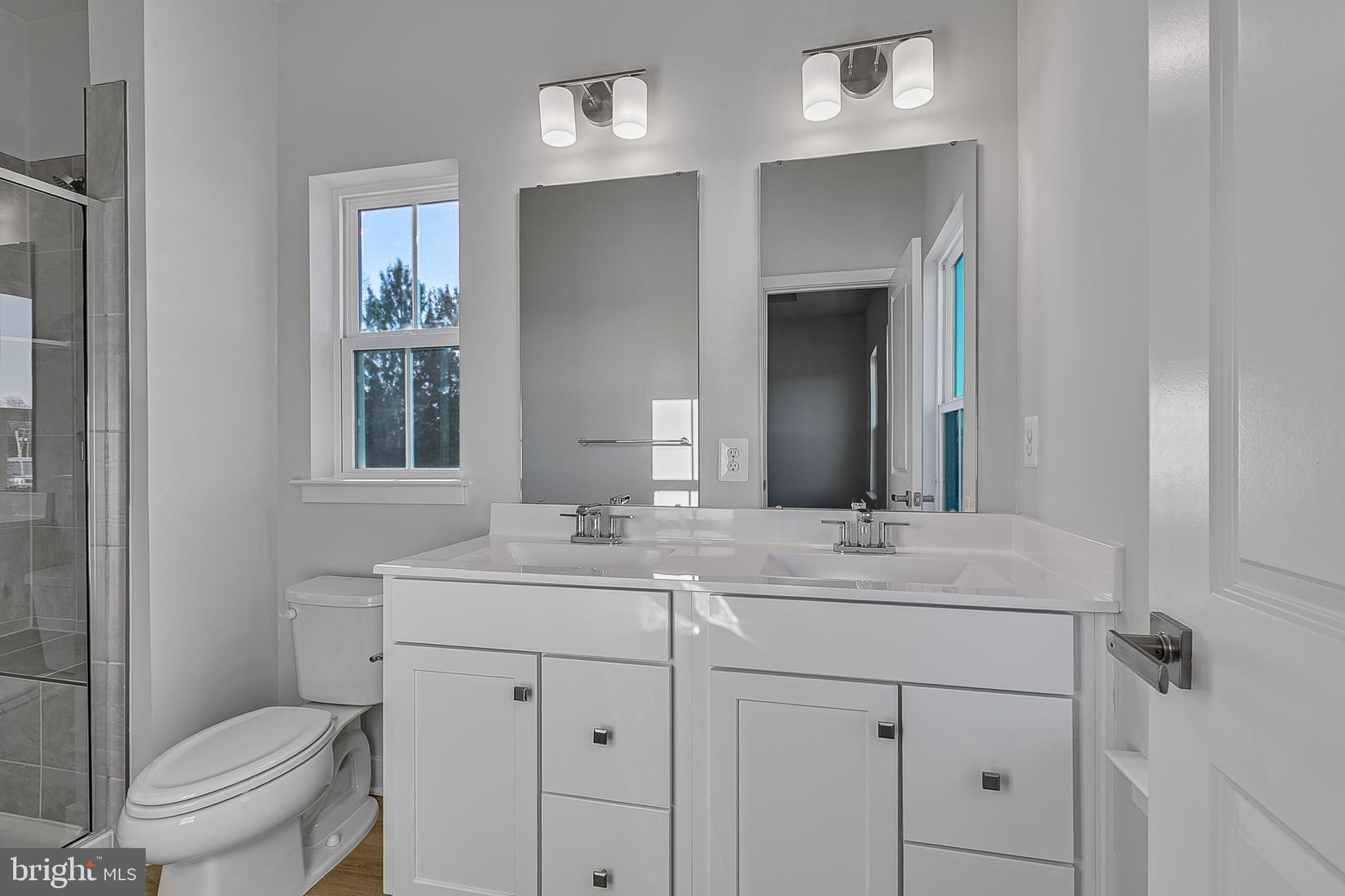 1101 Oasis Avenue Ranson, WV 25438 - Photo 39 of 39 a bathroom with a toilet sink and mirror