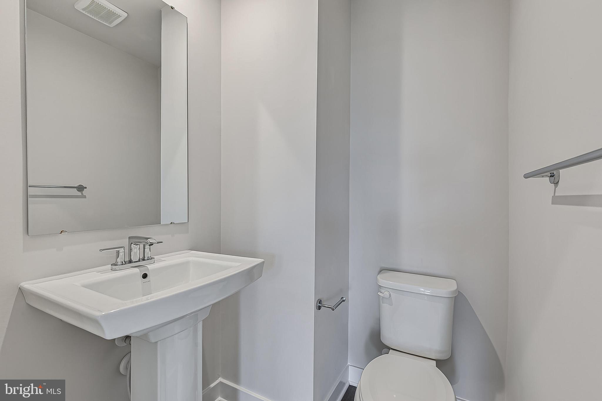 1101 Oasis Avenue Ranson, WV 25438 - Photo 8 of 39 a bathroom with a sink a toilet and a mirror