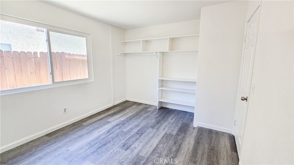 1025 Lightcap Street Lancaster, CA 93535 - Photo 13 of 13 an empty room with wooden floor and windows