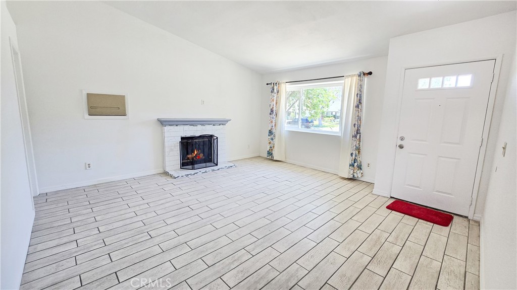 1025 Lightcap Street Lancaster, CA 93535 - Photo 6 of 13 a view of an empty room with wooden floor and a window