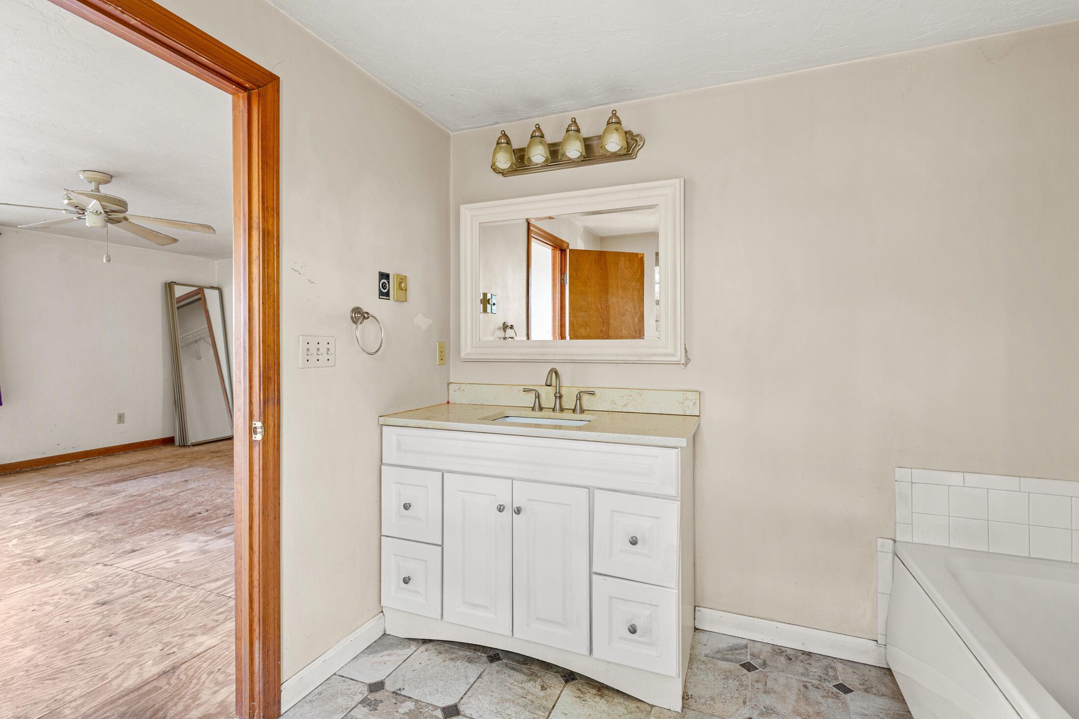 195 Falmouth Road, Unit 19F Mashpee, MA 02649 - Photo 23 of 25 a bathroom with a sink a mirror and a shower