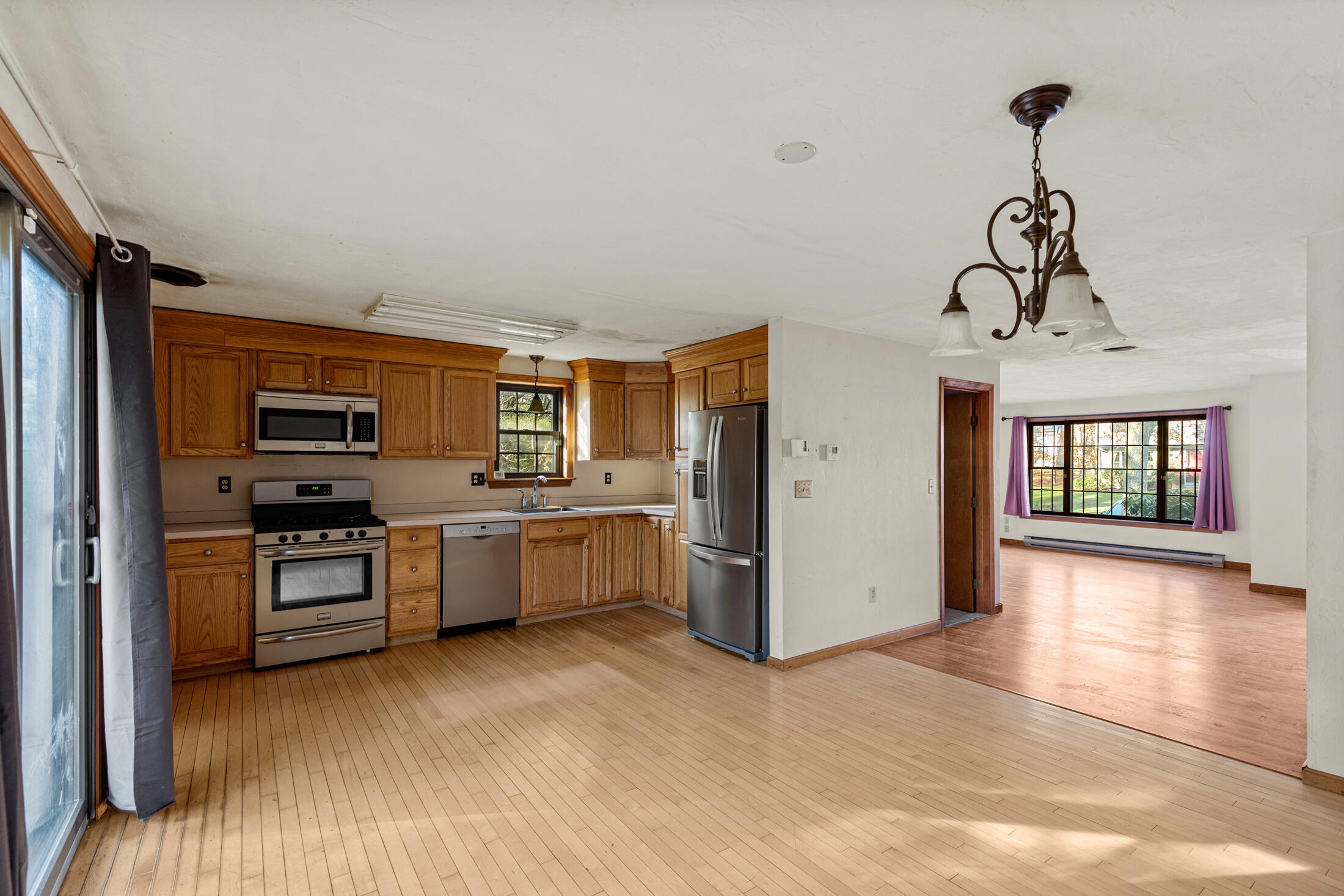 195 Falmouth Road, Unit 19F Mashpee, MA 02649 - Photo 3 of 25 a kitchen with stainless steel appliances granite countertop a refrigerator and a stove top oven
