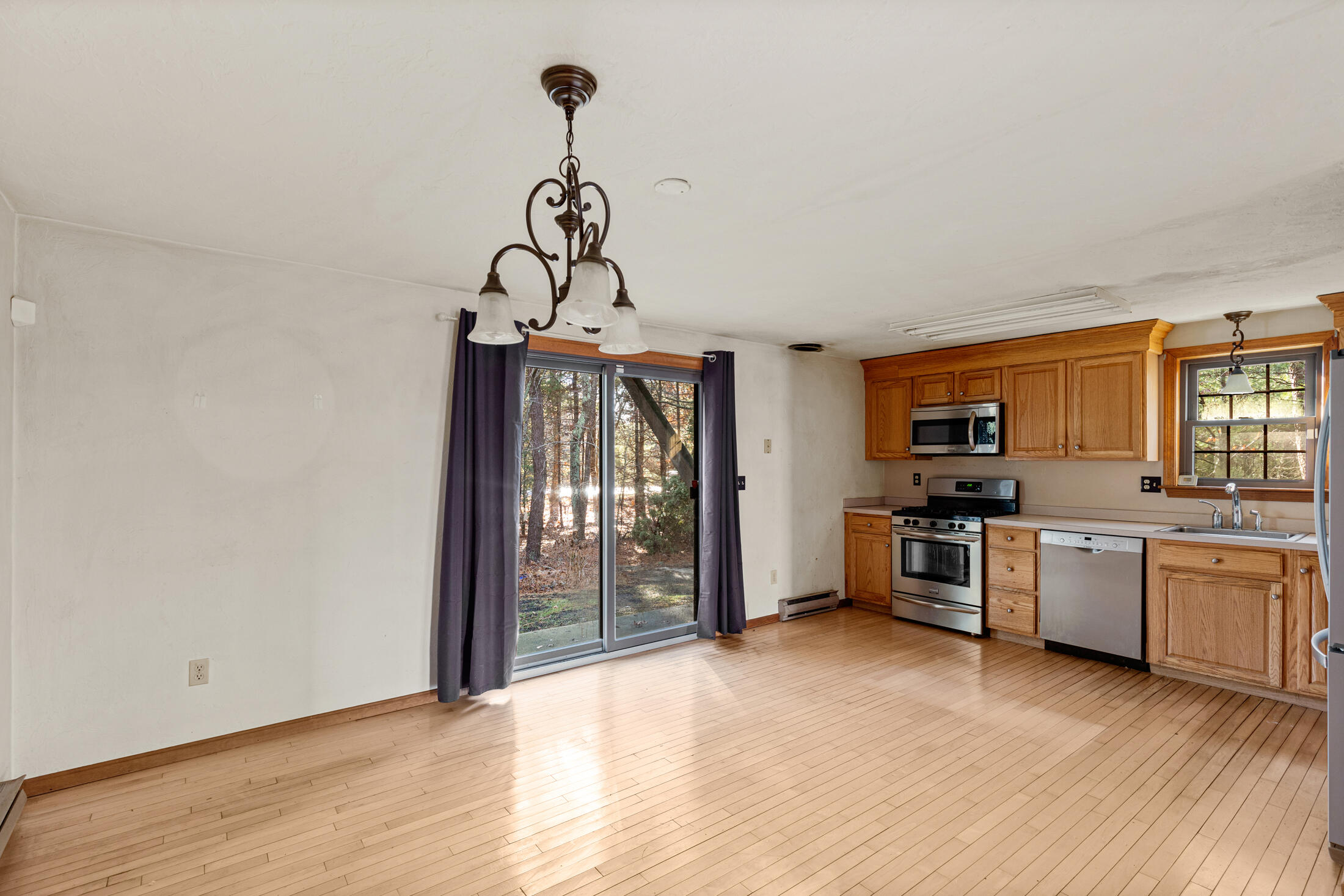 195 Falmouth Road, Unit 19F Mashpee, MA 02649 - Photo 4 of 25 a kitchen with stainless steel appliances granite countertop a stove and a refrigerator