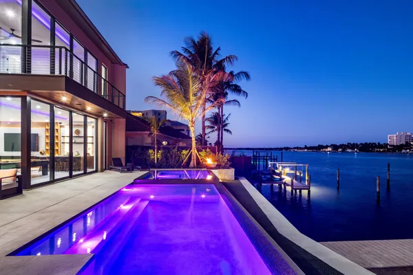 a living room with furniture a flat screen tv and a large window