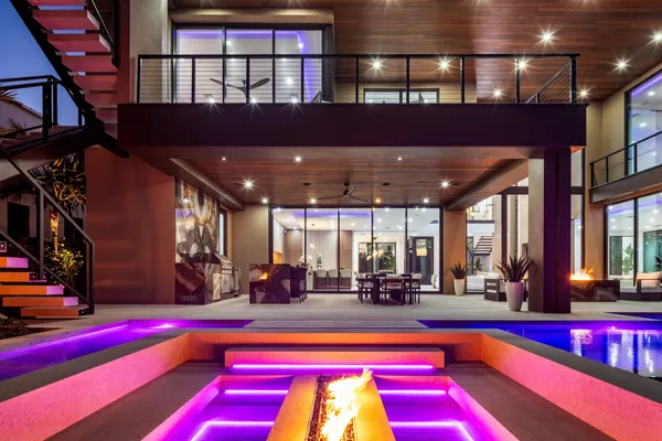 a living room with furniture a large window and a potted plant