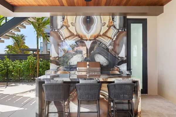 a living room with furniture a chandelier and a floor to ceiling window