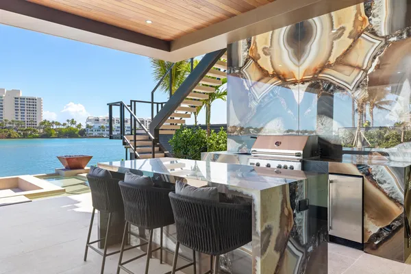 a view of a patio with a dining table and chairs