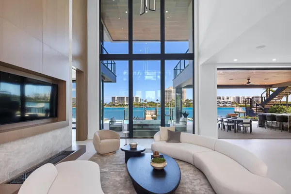 a dining room with furniture and a floor to ceiling window