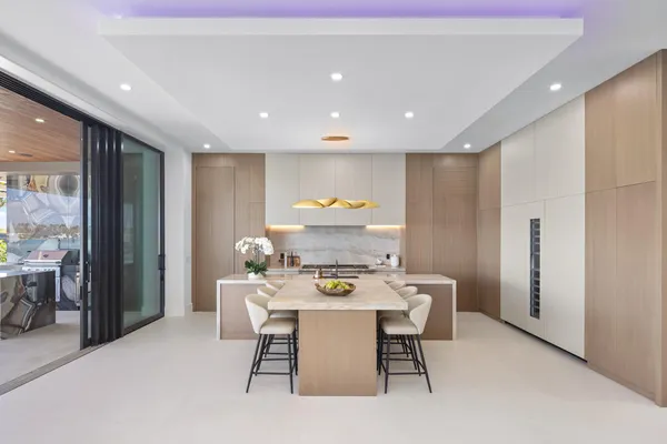 a dining room with furniture and large windows