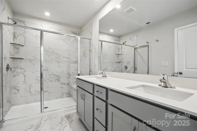 a bathroom with a shower sink and mirror